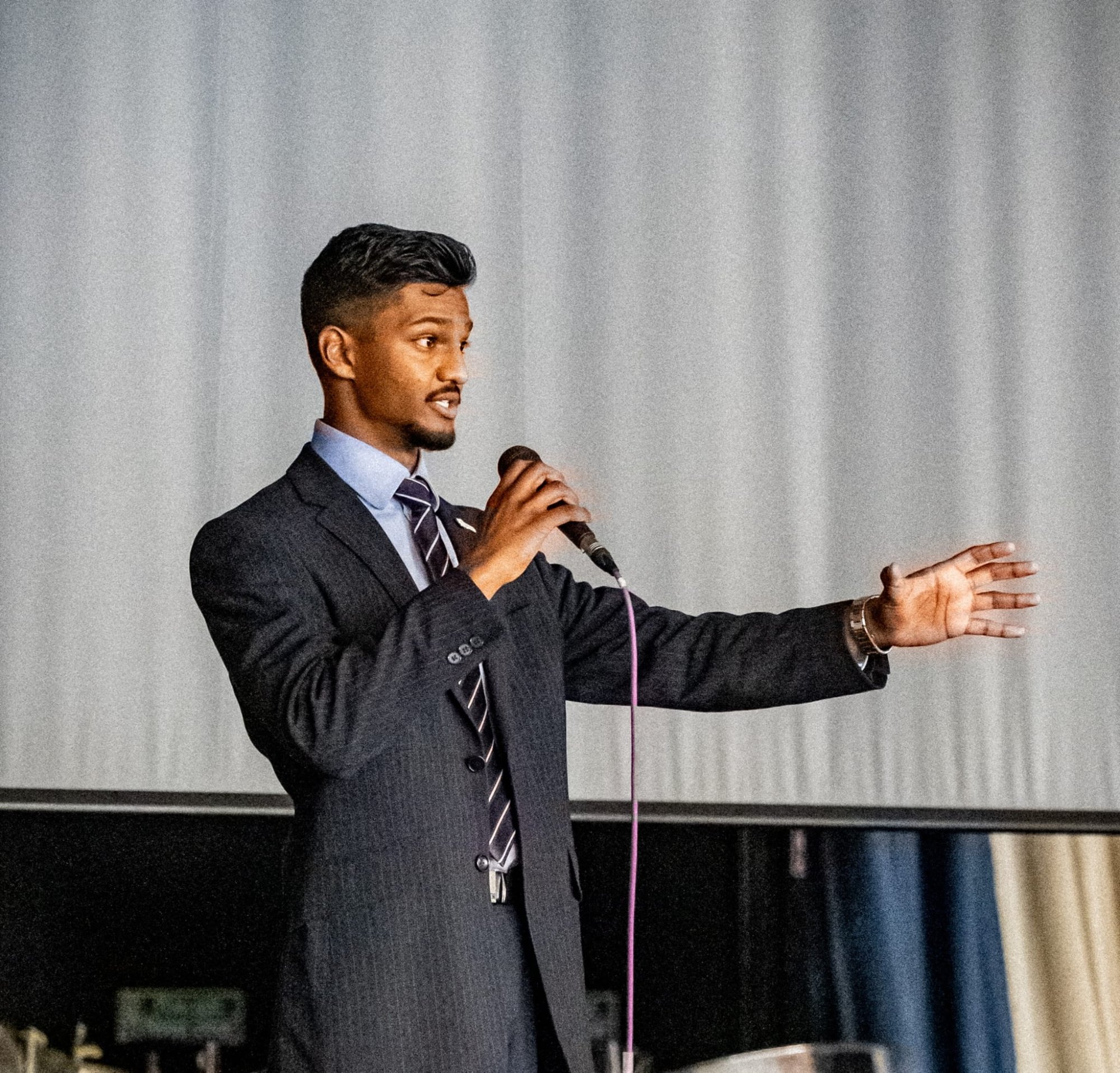 Mohammad Usman speaking on stage